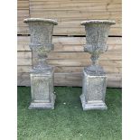 Pair of ornate Victorian style urns on plinth base