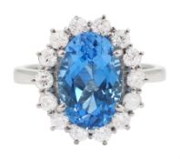 18ct white gold oval cut Swiss blue topaz and round brilliant cut diamond cluster ring
