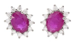 Pair of 18ct white gold oval cut ruby and round brilliant cut diamond cluster stud earrings