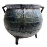 A Victorian cast iron twin handled cauldron.