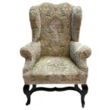 A George III elm framed wing back armchair.