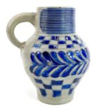 A saltglaze jug with blue incised feather decoration and chequered borders.