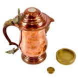 A copper and brass bound face mask lidded jug.