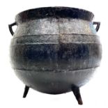 A Victorian cast iron large twin handled cauldron.