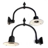 A pair of wrought iron wall mounted street lanterns.