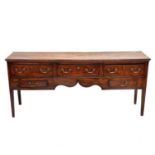 A George III oak and elm low dresser.