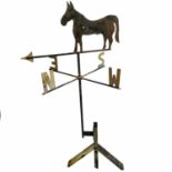 A wrought iron weather vane decorated with a horse.