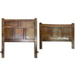 An 18th century panelled oak bedhead and end.