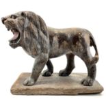A carved wood and painted figure of a lion.