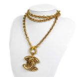A Chanel gold tone CC pendant necklace.