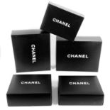 Five large Chanel retail boxes.