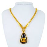 A Chanel brown stone set pendant necklace.
