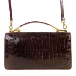 A vintage brown crocodile leather handbag.