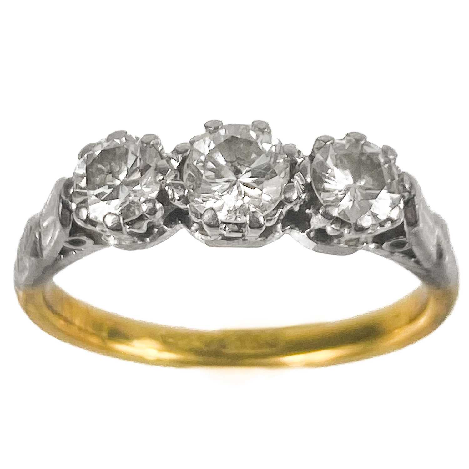 An 18ct gold and platinum diamond set three stone ring.