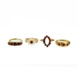 Four various garnet set rings.