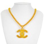 A Chanel gold tone CC pendant necklace.