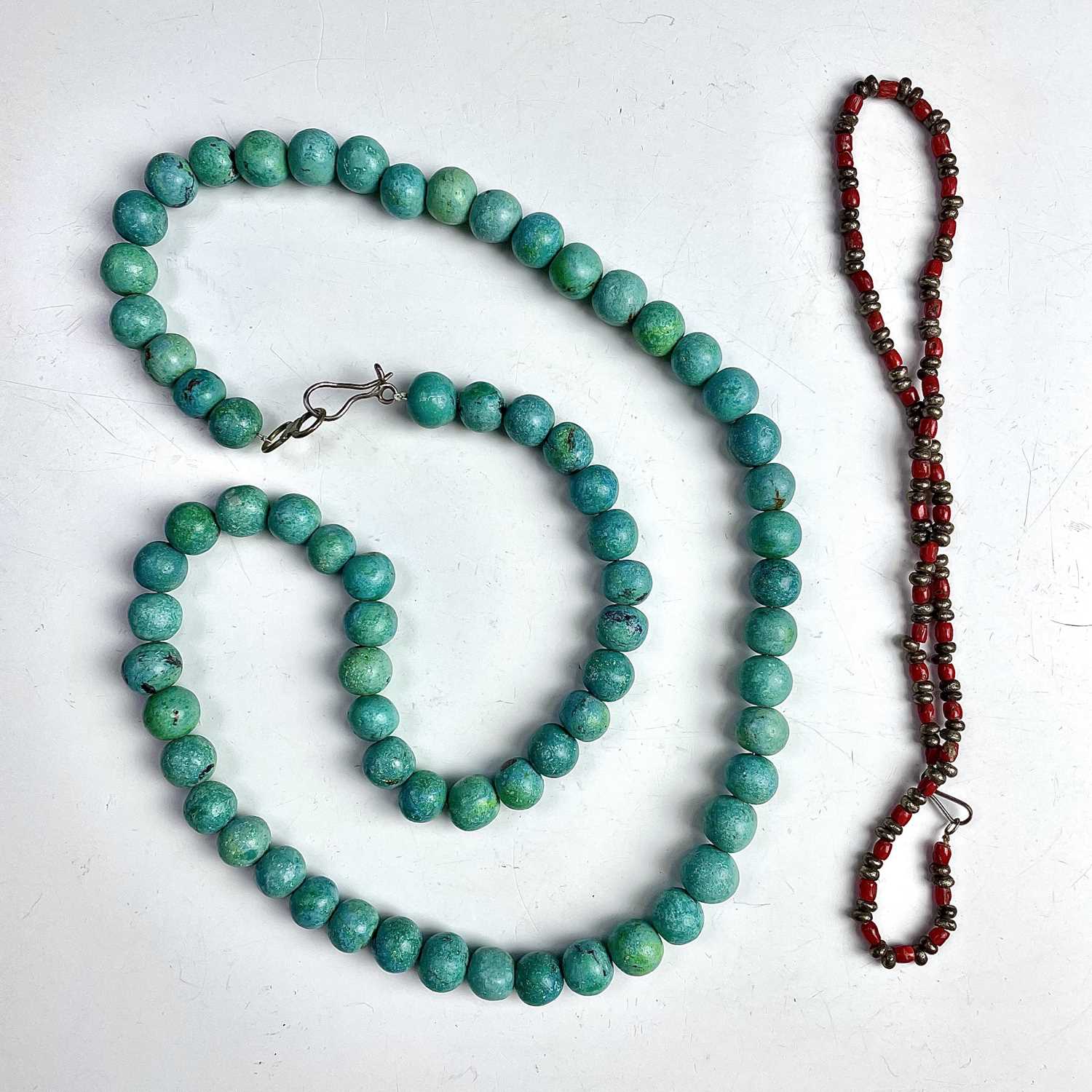 A turquoise bead necklace with low grade silver clasp.