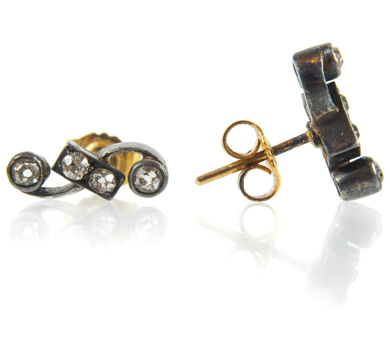 A pair of early 20th century bi-colour gold and diamond set stud earrings.