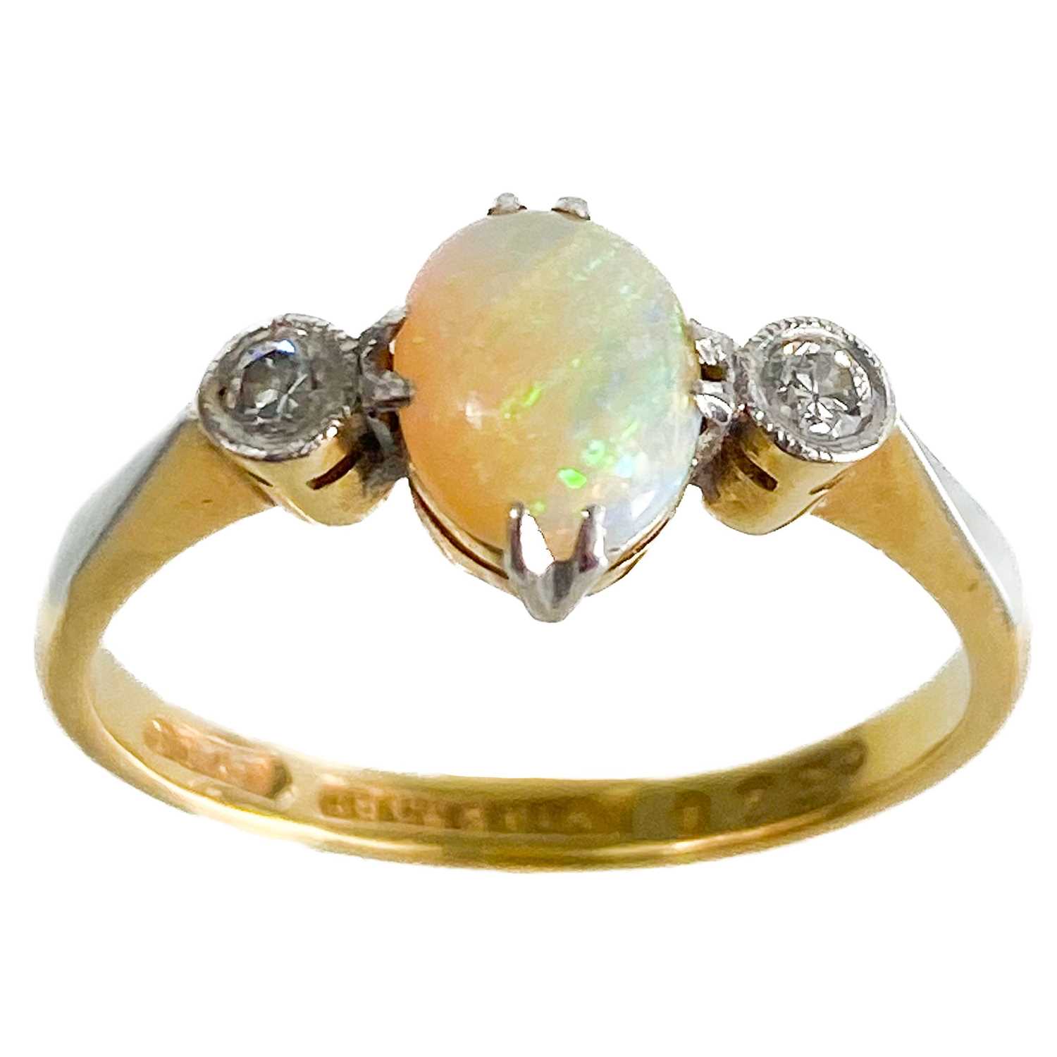 An early 20th century 18ct and platinum diamond and opal set three stone ring.