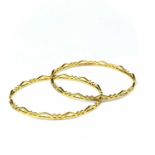 An Indian 22ct gold pair of bangles.