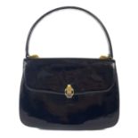 A Gucci black patent leather evening handbag.