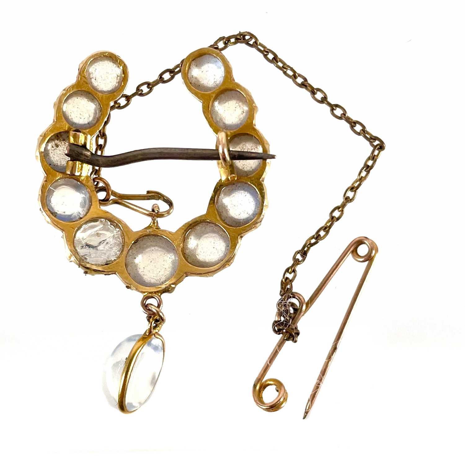 A gold and moonstone set horse shoe brooch. - Image 2 of 2