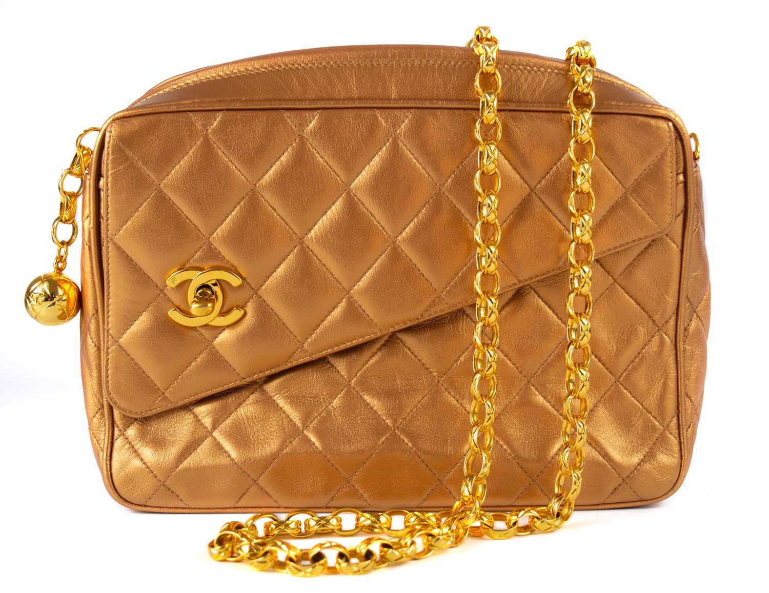 A Chanel gold quilted leather turn lock camera bag.