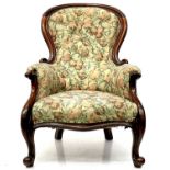 A Victorian walnut spoon back armchair.