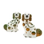 A pair of Victorian green and copper lustre spaniels.