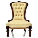 A Victorian walnut upholstered nursing chair.