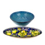 A large studio pottery fruit bowl together with an oval serving dish.