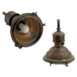 A pair of copper industrial ceiling lamp pendants.
