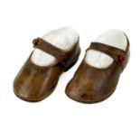 A pair of leather shoes for a baby or toddler.