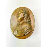A 19th century oval table snuff box embossed with a profile portrait of Cromwell.