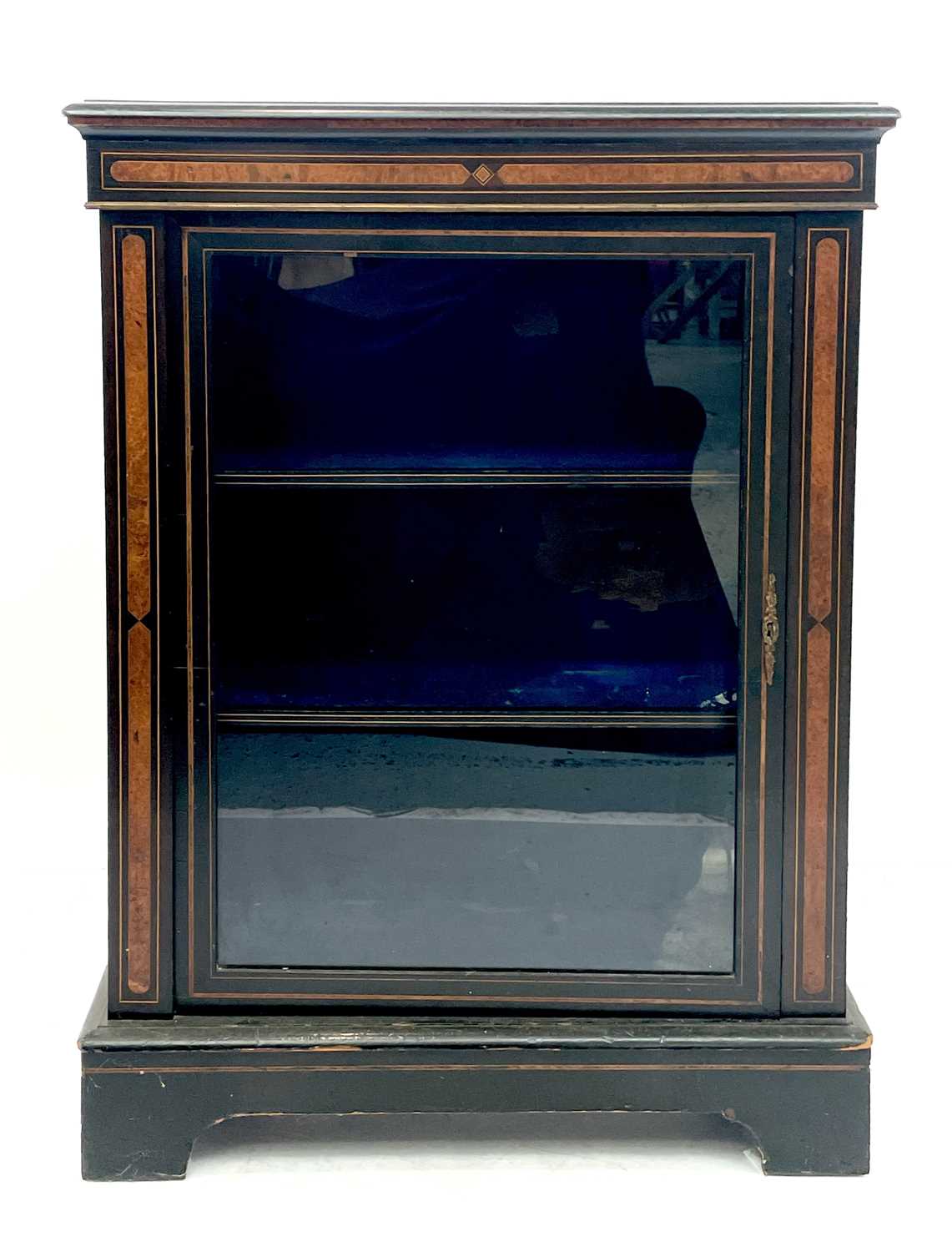 A Victorian ebonised walnut inlaid pier cabinet with brass mounts and boxwood stringing.