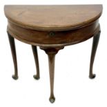 A George II mahogany demi lune fold top table.