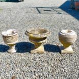 A carved white marble garden urn on a pedestal base on a square base.