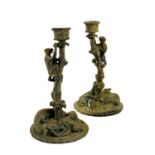 A pair of bronze candlesticks.