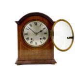 An Edwardian mahogany dome top mahogany and line inlaid mantel clock.