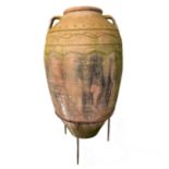 A large terracotta olive jar.