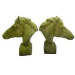 A pair of reconstituted stone models of horse heads.