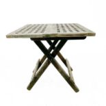 A small teak folding table the top styled as ship grating.