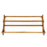 An Ercol elm wall hanging plate rack.