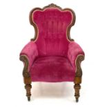 A Victorian walnut upholstered spoon back armchair.