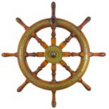 A brass mounted teak eight spoke ship's wheel.