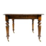 A late Victorian oak extending dining table.