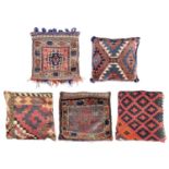Five cushions to include four Persian and one Turkoman.
