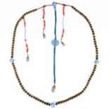 A Chinese Qing dynasty Peking blue glass, carved nut and coral bead court necklace.