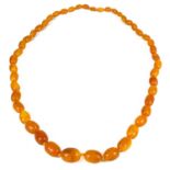 A butterscotch amber oval graduated bead necklace.