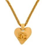 A Chanel gold tone heart and CC pendant necklace.